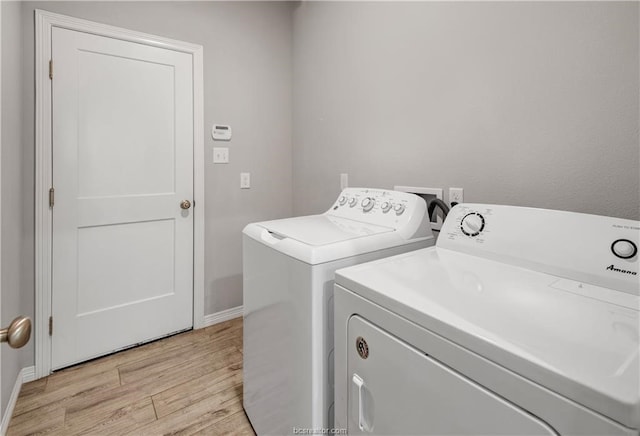 washroom featuring light hardwood / wood-style floors, washing machine and dryer, and washer hookup