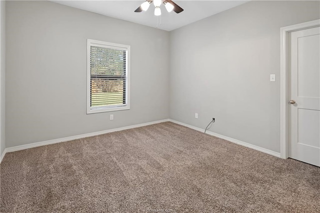 carpeted spare room with ceiling fan