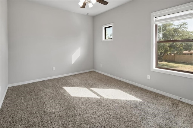 carpeted empty room featuring plenty of natural light and ceiling fan