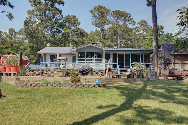 rear view of house featuring a yard