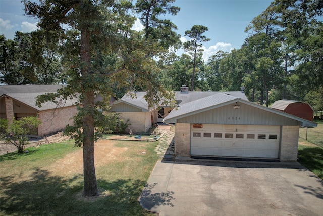 view of front of house with a front yard and a garage