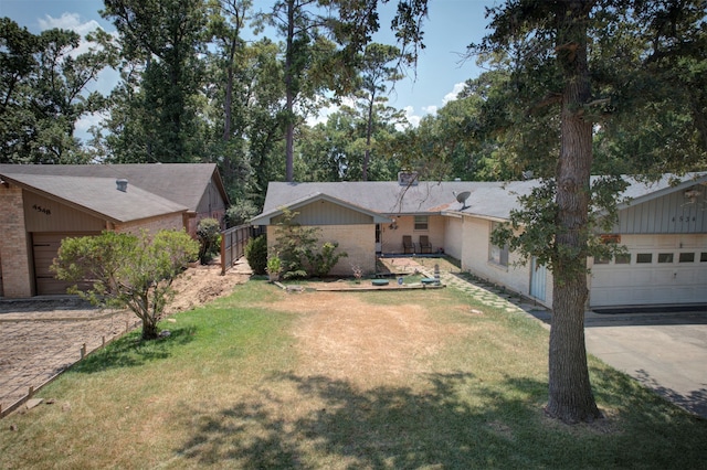 ranch-style home featuring a garage and a front lawn