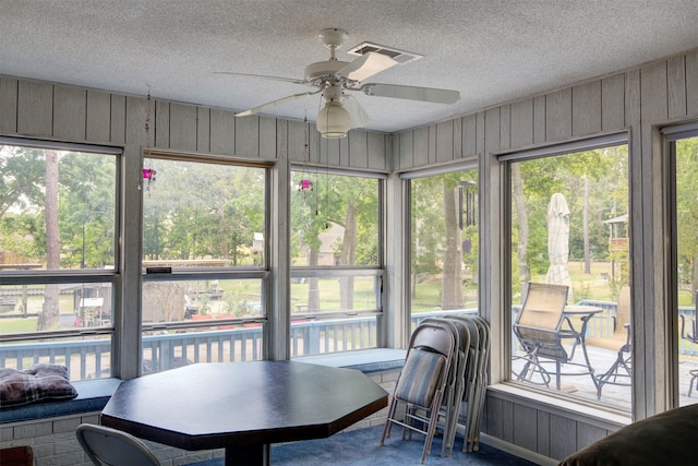 sunroom / solarium featuring a wealth of natural light and ceiling fan