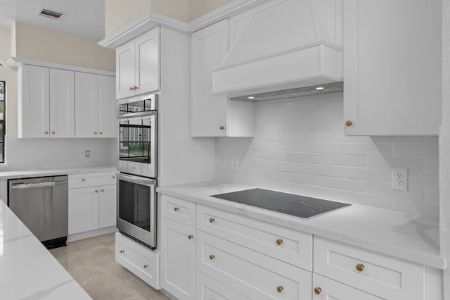 17402 Wilton Park Ct, Spring, TX 77379 - kitchen with stainless steel appliances, white cabinets, backsplash, light tile flooring, and custom exhaust hood