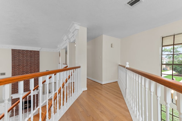 17402 Wilton Park Ct, Spring, TX 77379 - hall featuring light hardwood / wood-style flooring, a textured ceiling, and brick wall