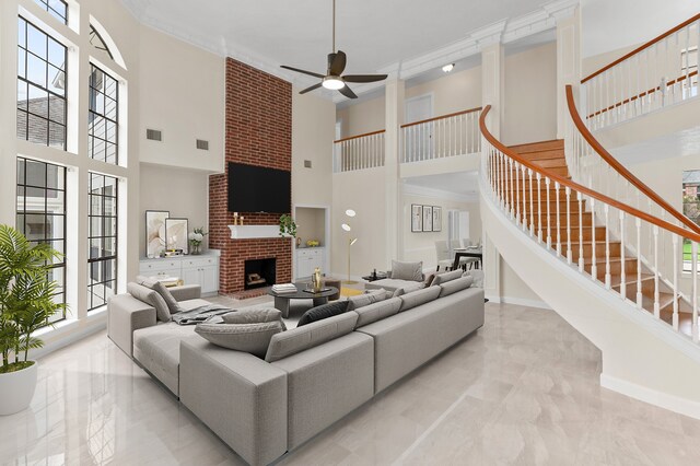 17402 Wilton Park Ct, Spring, TX 77379 - tiled living room featuring a brick fireplace, a towering ceiling, ornamental molding, and ceiling fan