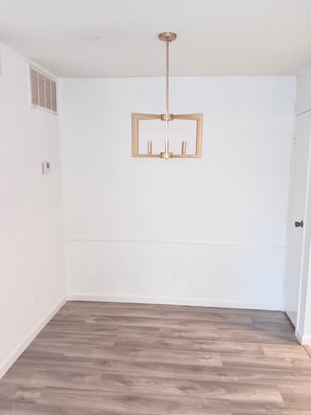 unfurnished dining area featuring wood-type flooring