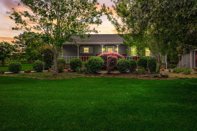 ranch-style home featuring a lawn