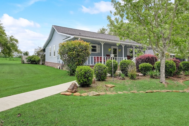 view of front of home featuring a front yard and covered porch