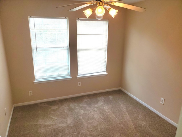 spare room featuring carpet flooring and ceiling fan