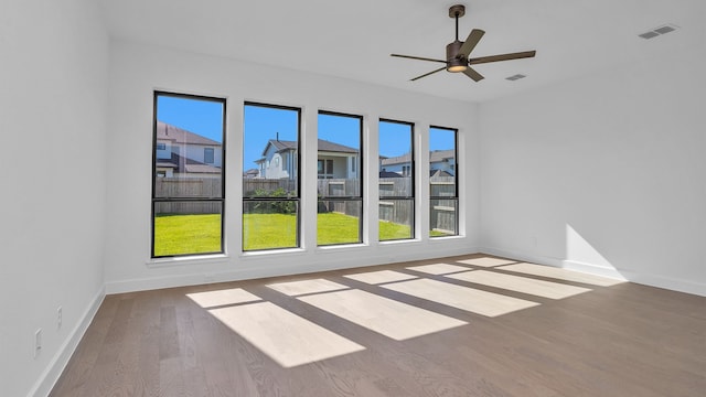 unfurnished room featuring ceiling fan and hardwood / wood-style flooring