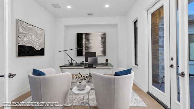 office featuring french doors and light hardwood / wood-style flooring