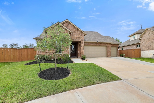 view of front of home with a front yard and a garage