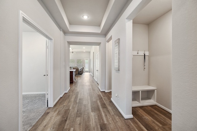 hall with wood-type flooring and an inviting chandelier