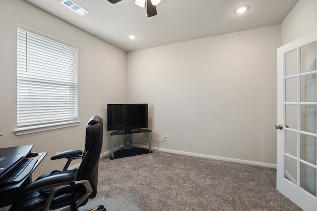 carpeted office with ceiling fan