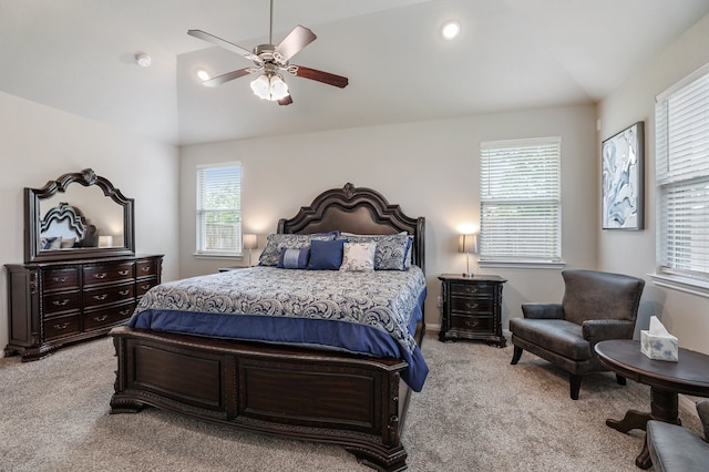 bedroom with multiple windows, ceiling fan, light carpet, and lofted ceiling