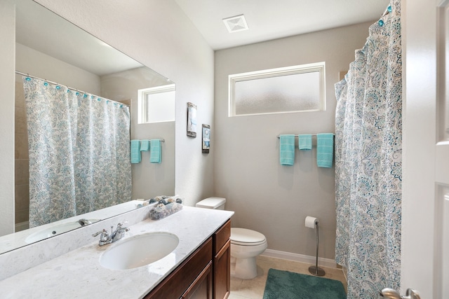 bathroom with tile patterned flooring, vanity, and toilet