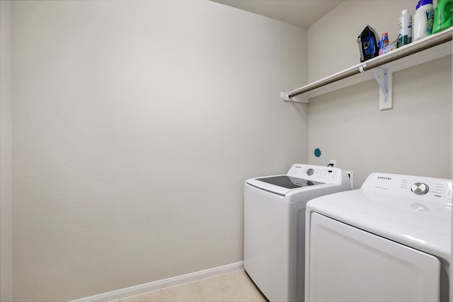 laundry area featuring light tile patterned flooring and independent washer and dryer