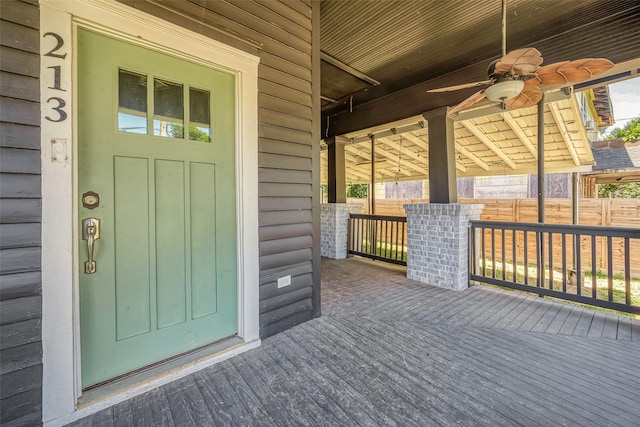 doorway to property featuring ceiling fan