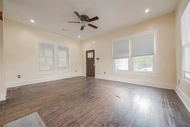 empty room with ceiling fan and dark hardwood / wood-style flooring