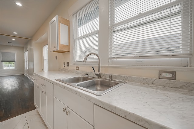 kitchen featuring light hardwood / wood-style flooring, white cabinets, and sink