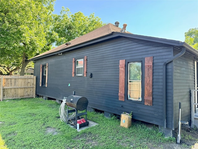 view of property exterior featuring a lawn