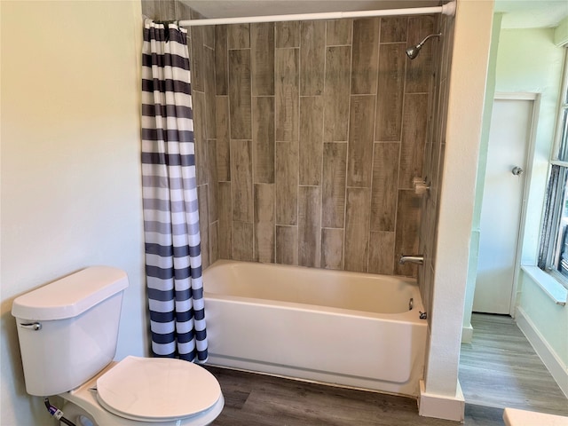 bathroom with shower / bathtub combination with curtain, hardwood / wood-style flooring, and toilet