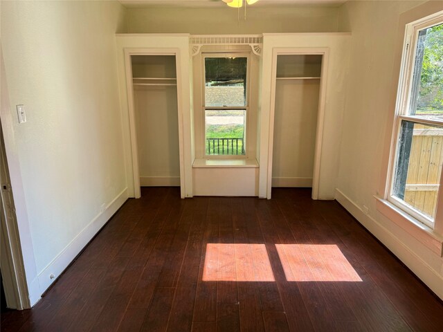 unfurnished bedroom with dark wood-type flooring