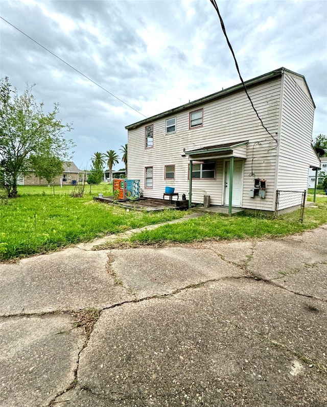 rear view of house with a lawn