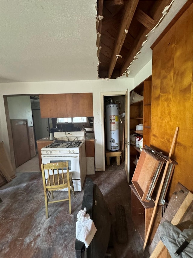 kitchen featuring a textured ceiling, white range with gas stovetop, and gas water heater