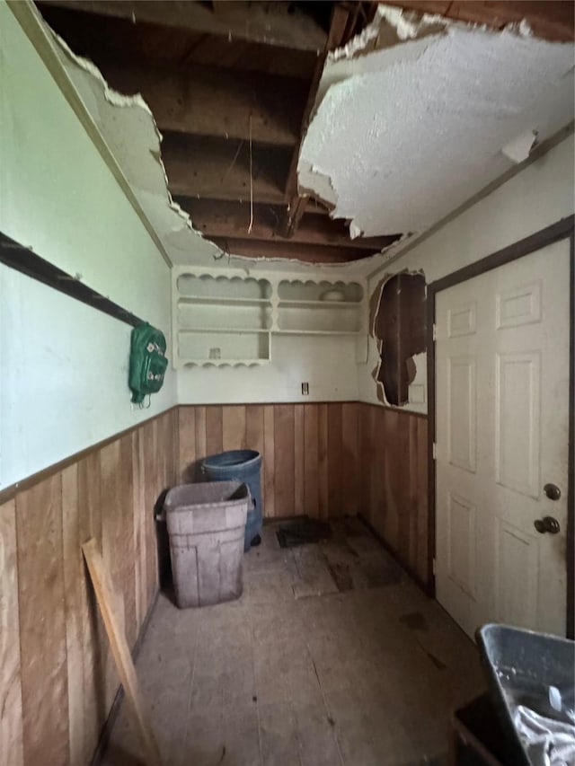 basement featuring wood walls