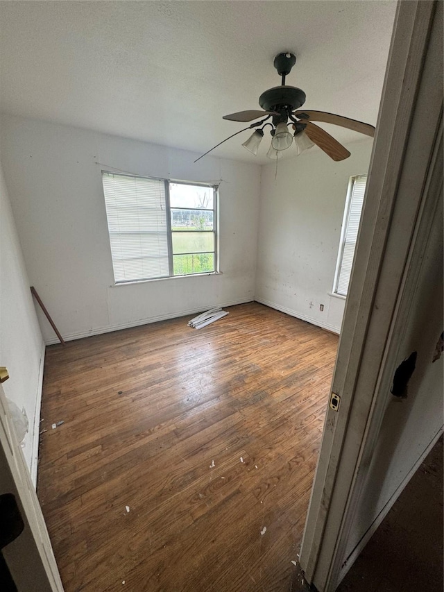 spare room featuring ceiling fan and dark hardwood / wood-style flooring