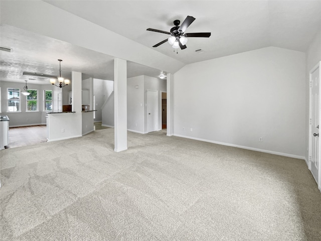 unfurnished living room with carpet, ceiling fan with notable chandelier, and lofted ceiling