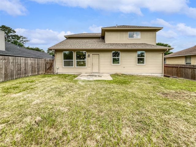 rear view of property featuring a patio and a lawn