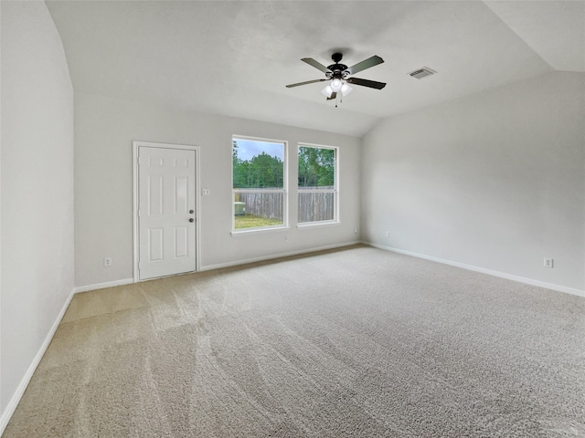 carpeted spare room featuring ceiling fan and lofted ceiling