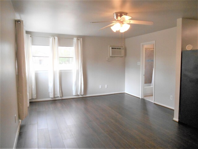 empty room featuring hardwood / wood-style floors, a wall mounted air conditioner, and ceiling fan