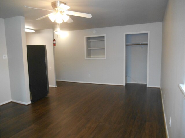 unfurnished bedroom featuring ceiling fan, dark hardwood / wood-style floors, and a closet