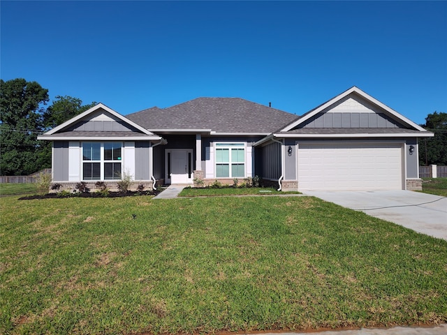 view of front of house featuring a front lawn and a garage