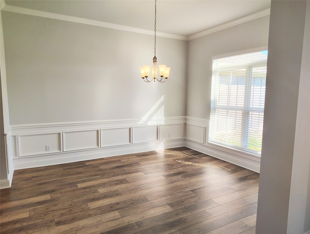 empty room with a chandelier, dark hardwood / wood-style floors, and crown molding