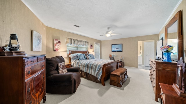 carpeted bedroom featuring a textured ceiling and ceiling fan