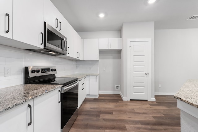 kitchen featuring dark wood-type flooring, backsplash, and appliances with stainless steel finishes