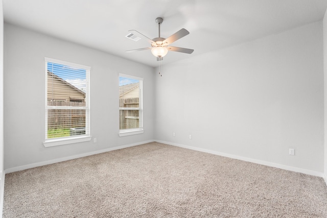 carpeted empty room featuring ceiling fan