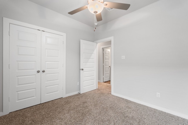 unfurnished bedroom with a closet, ceiling fan, and carpet floors