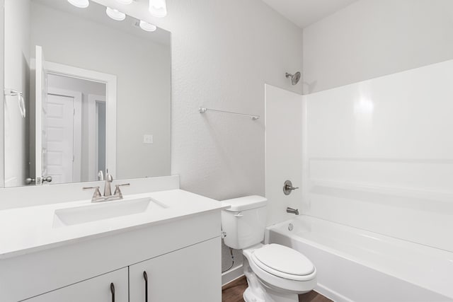 full bathroom with tub / shower combination, hardwood / wood-style floors, toilet, and large vanity