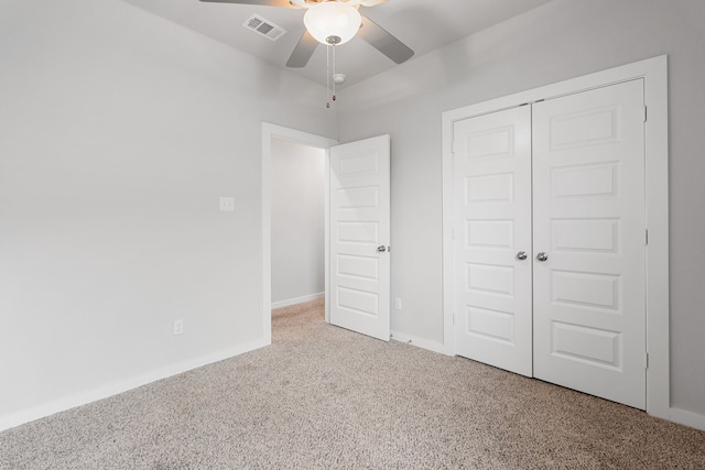 unfurnished bedroom featuring a closet, carpet floors, and ceiling fan