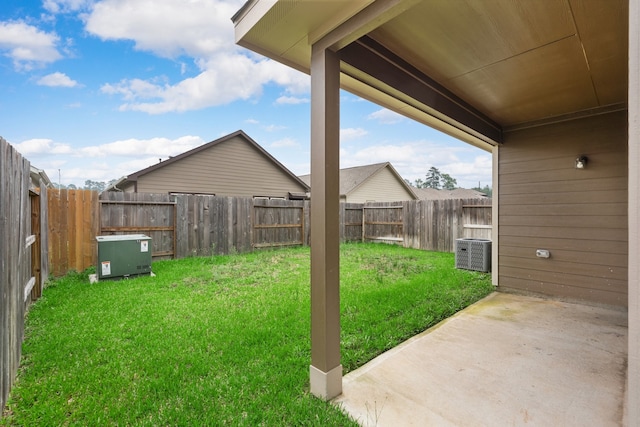 view of yard with central AC unit and a patio