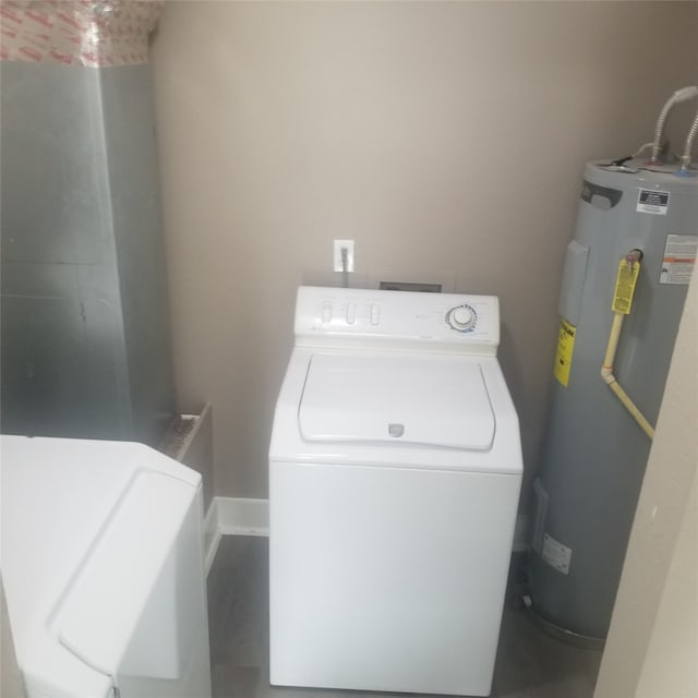 clothes washing area with separate washer and dryer and electric water heater