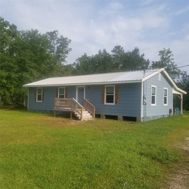 rear view of house with a yard