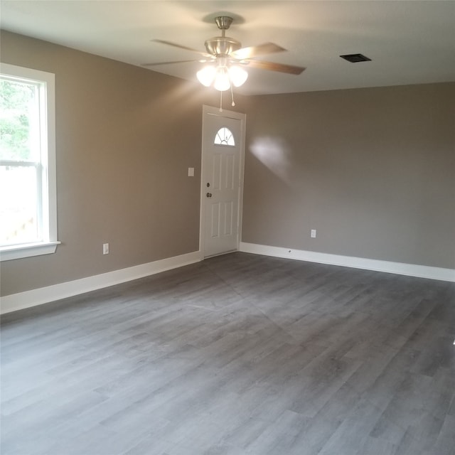 spare room featuring ceiling fan and dark wood-type flooring