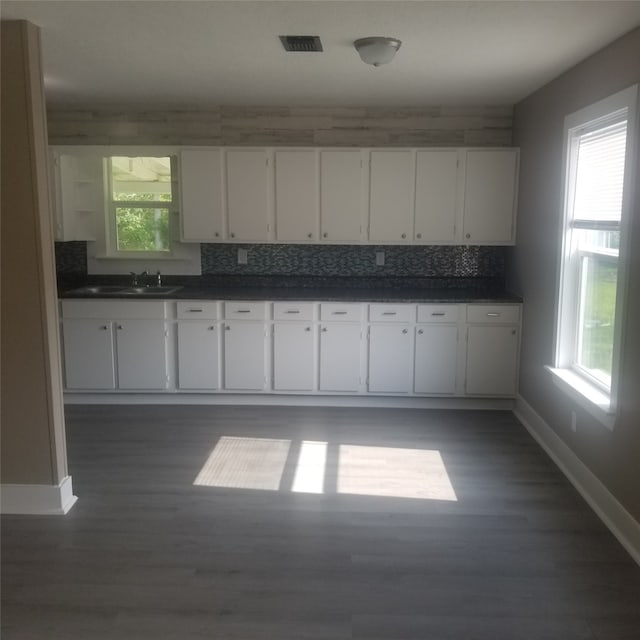 kitchen with sink, white cabinets, backsplash, and plenty of natural light